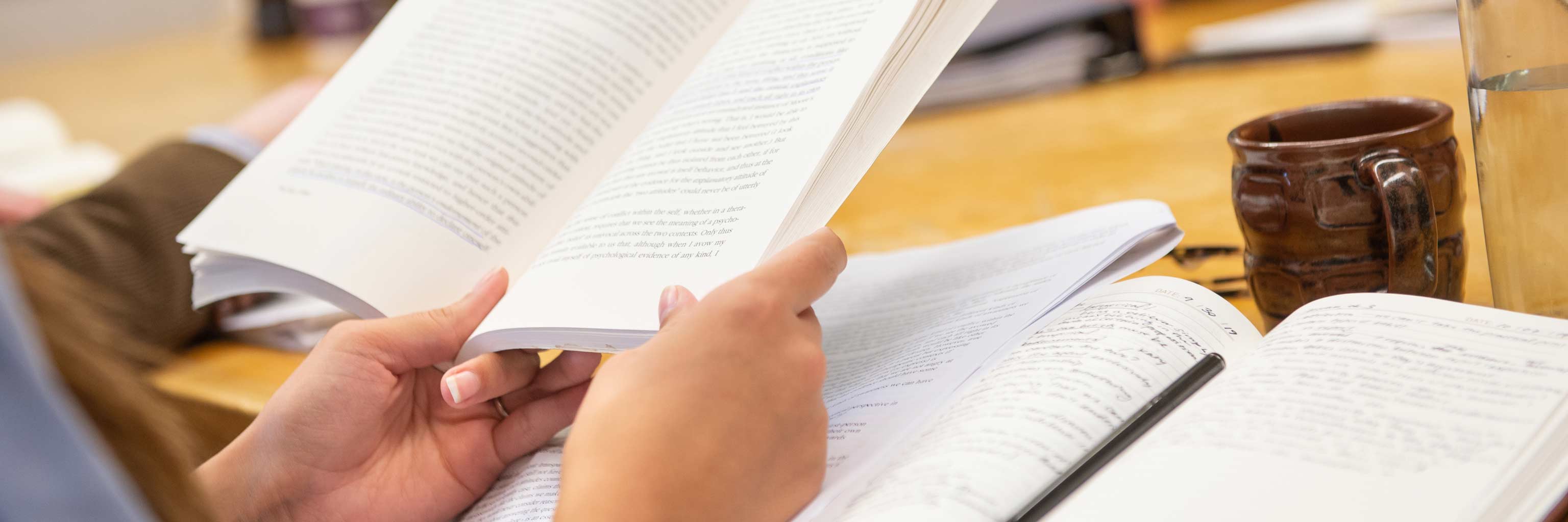 Close up of hands holding a book.