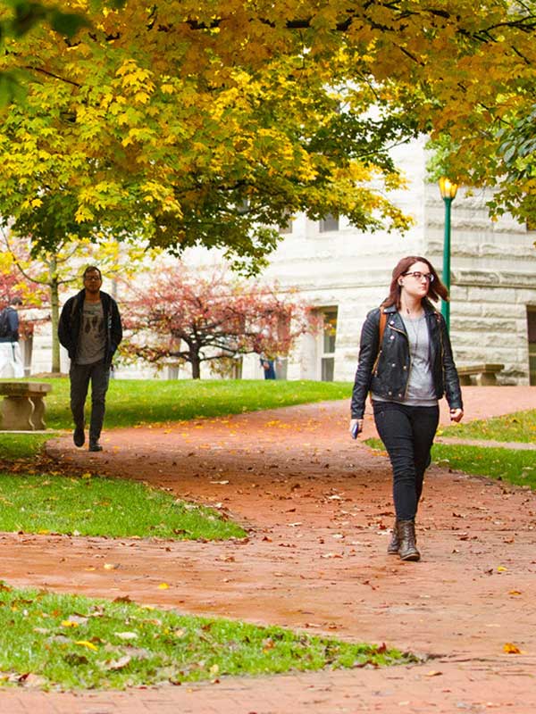 A photo of campus, with students walking through the Old Crescent.