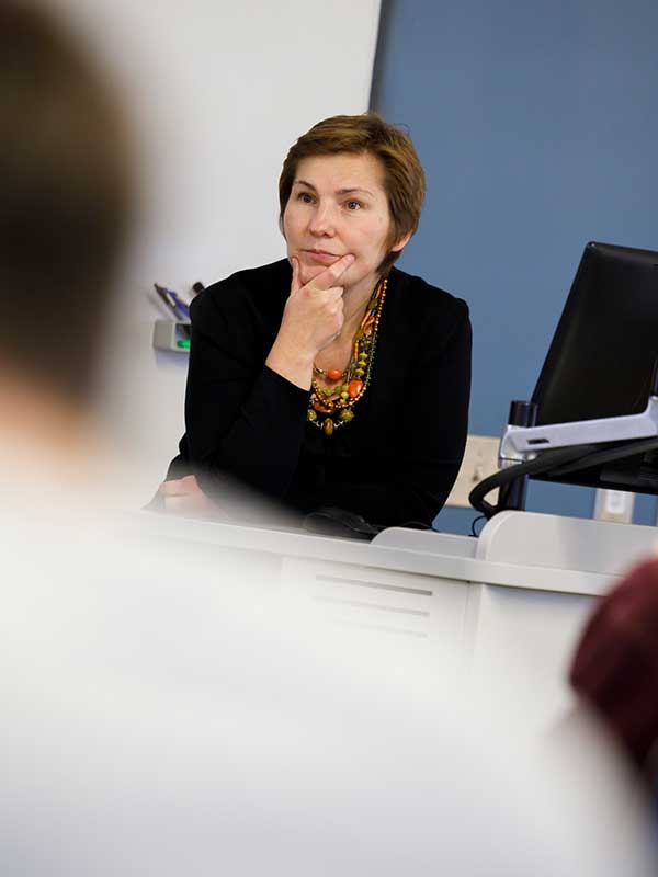 A professor lectures to a group of students.