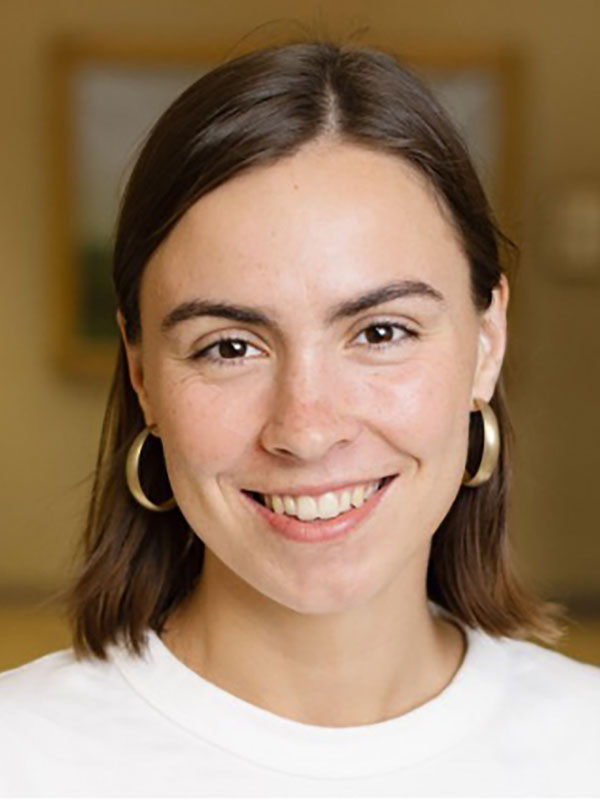 A headshot of Sadie McCloud, who wears a white shirt.